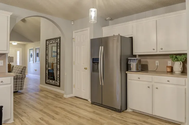 a kitchen with stainless steel appliances a refrigerator sink and cabinets