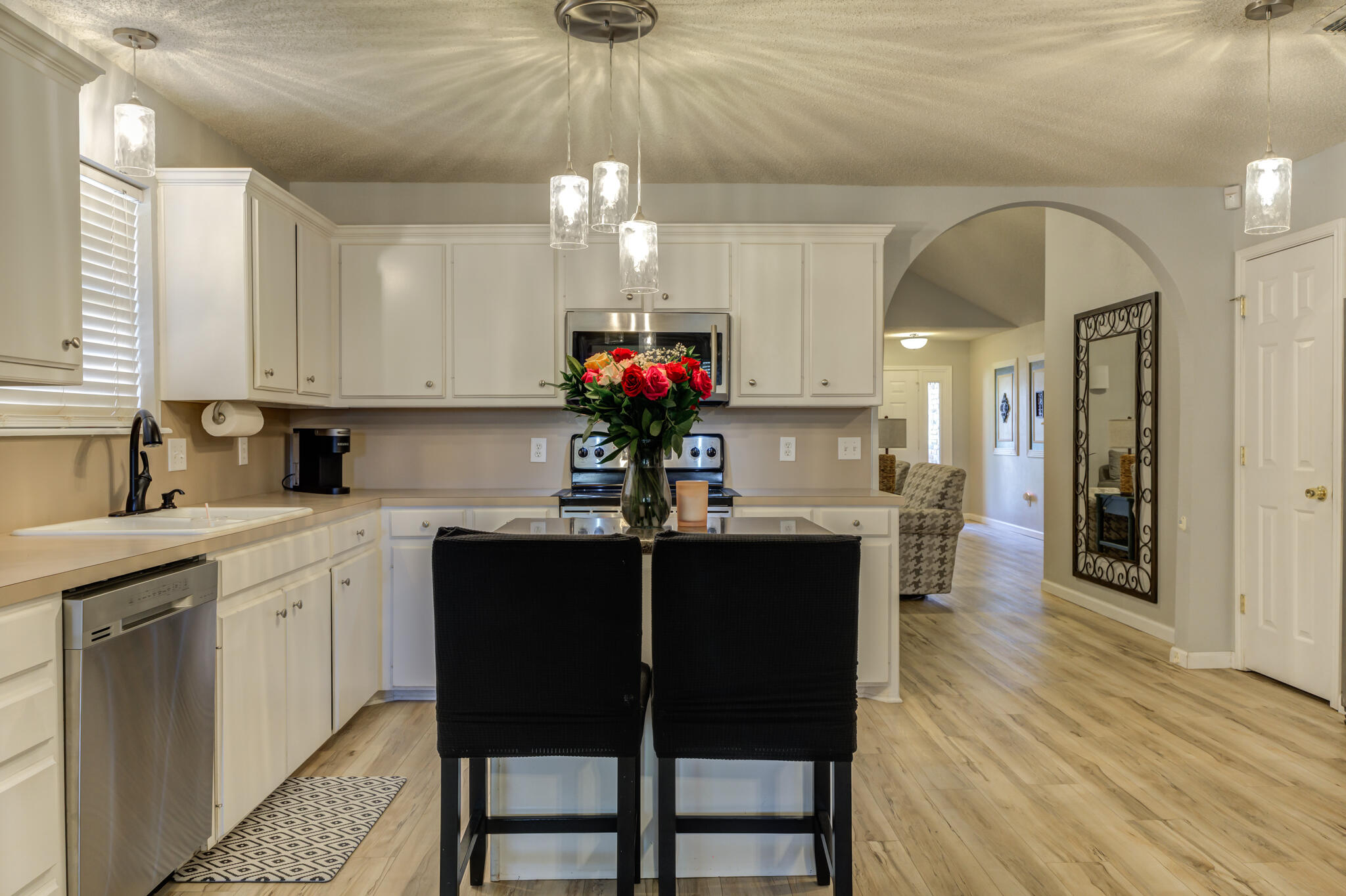 5813 88th Place Lubbock, TX 79424 - Photo 15 of 30 a kitchen with stainless steel appliances granite countertop a dining table chairs sink and cabinets