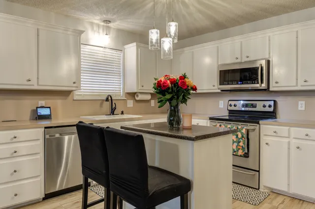 a view of a kitchen with a sink and microwave