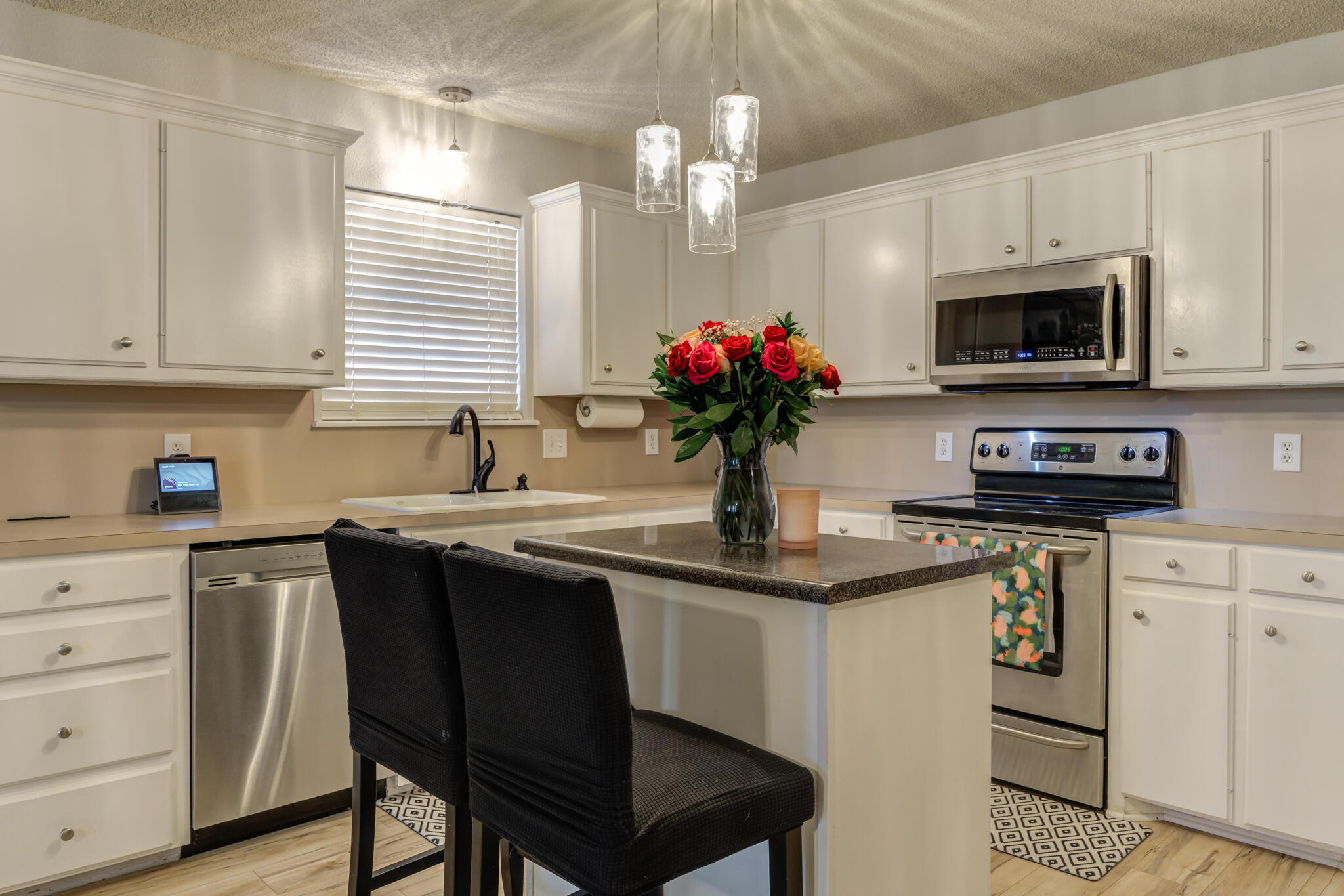 5813 88th Place Lubbock, TX 79424 - Photo 18 of 30 a view of a kitchen with a sink and microwave