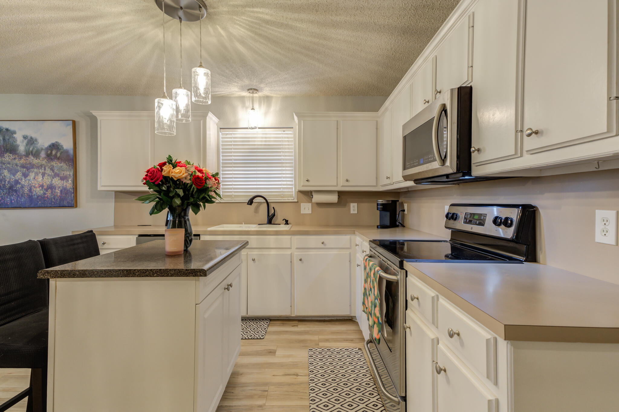 5813 88th Place Lubbock, TX 79424 - Photo 20 of 30 a kitchen with stainless steel appliances granite countertop a sink a stove top oven a counter space and cabinets