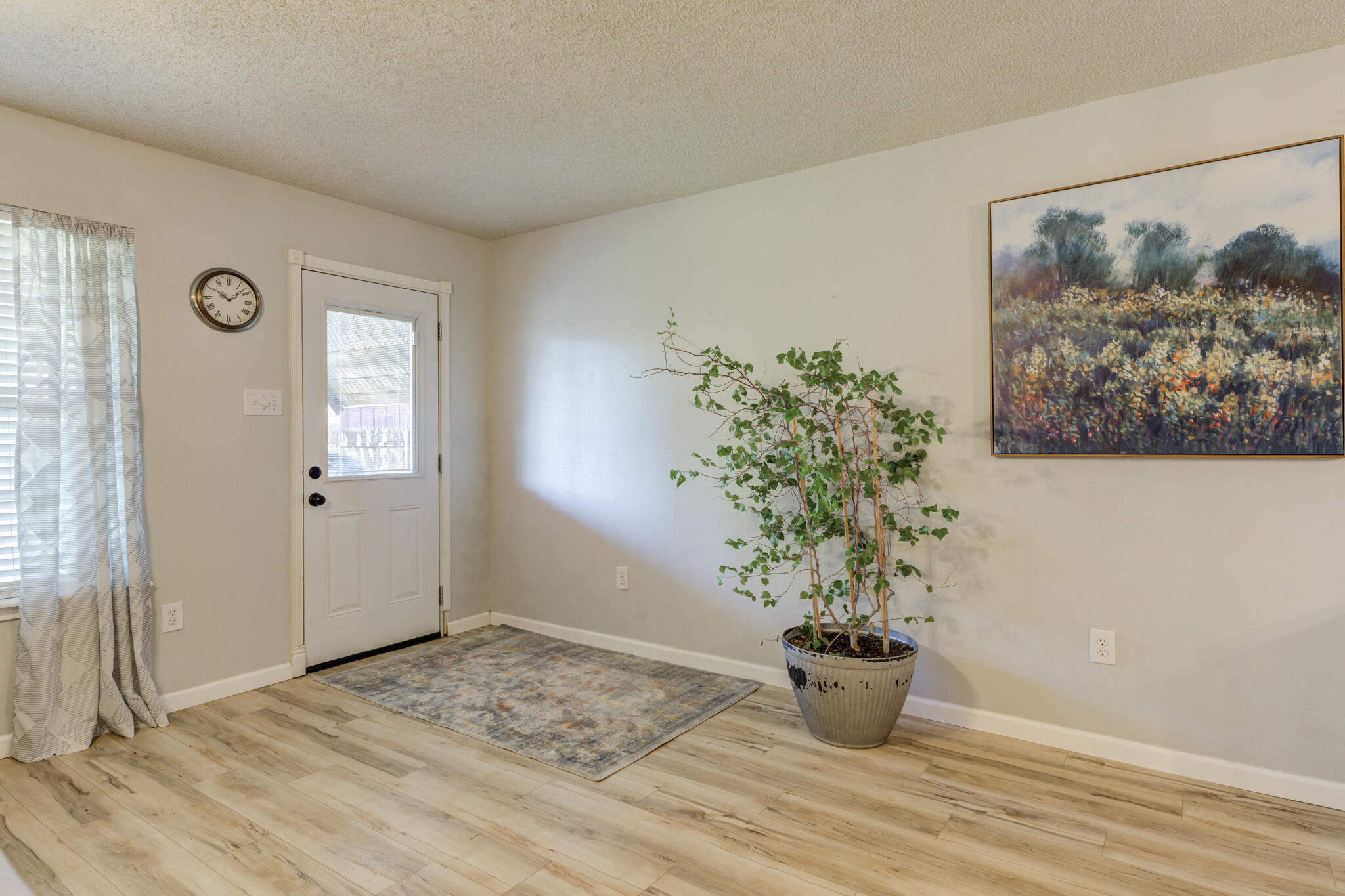 5813 88th Place Lubbock, TX 79424 - Photo 22 of 30 a view of a hallway with wooden floor and a potted plant