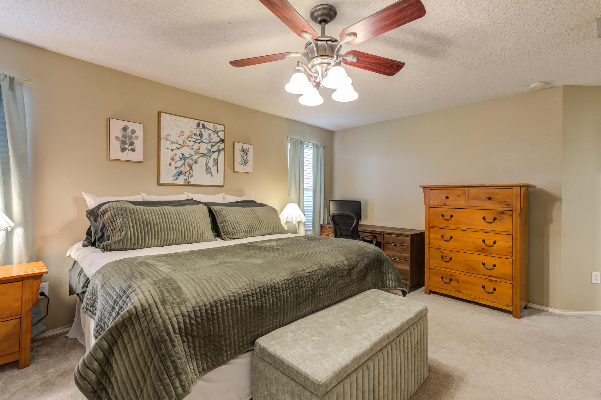 5813 88th Place Lubbock, TX 79424 - Photo 23 of 30 a bedroom with a bed and a chandelier