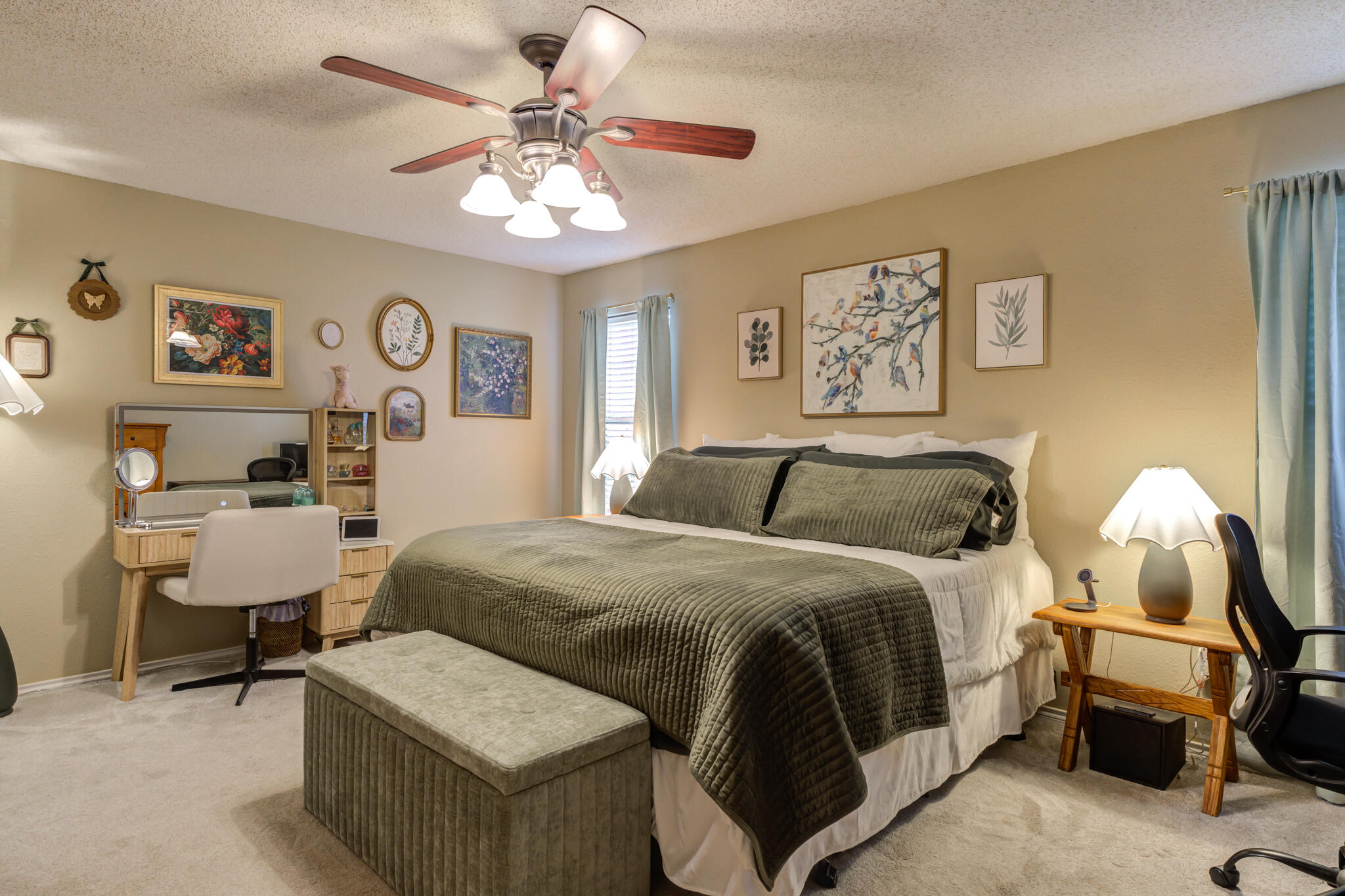5813 88th Place Lubbock, TX 79424 - Photo 24 of 30 a spacious bedroom with a bed and a chandelier