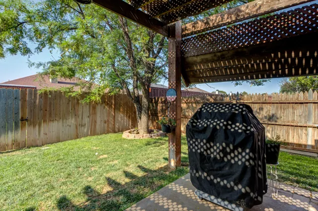 a view of a wooden bench with wooden fence