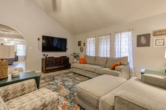 a living room with furniture and a flat screen tv