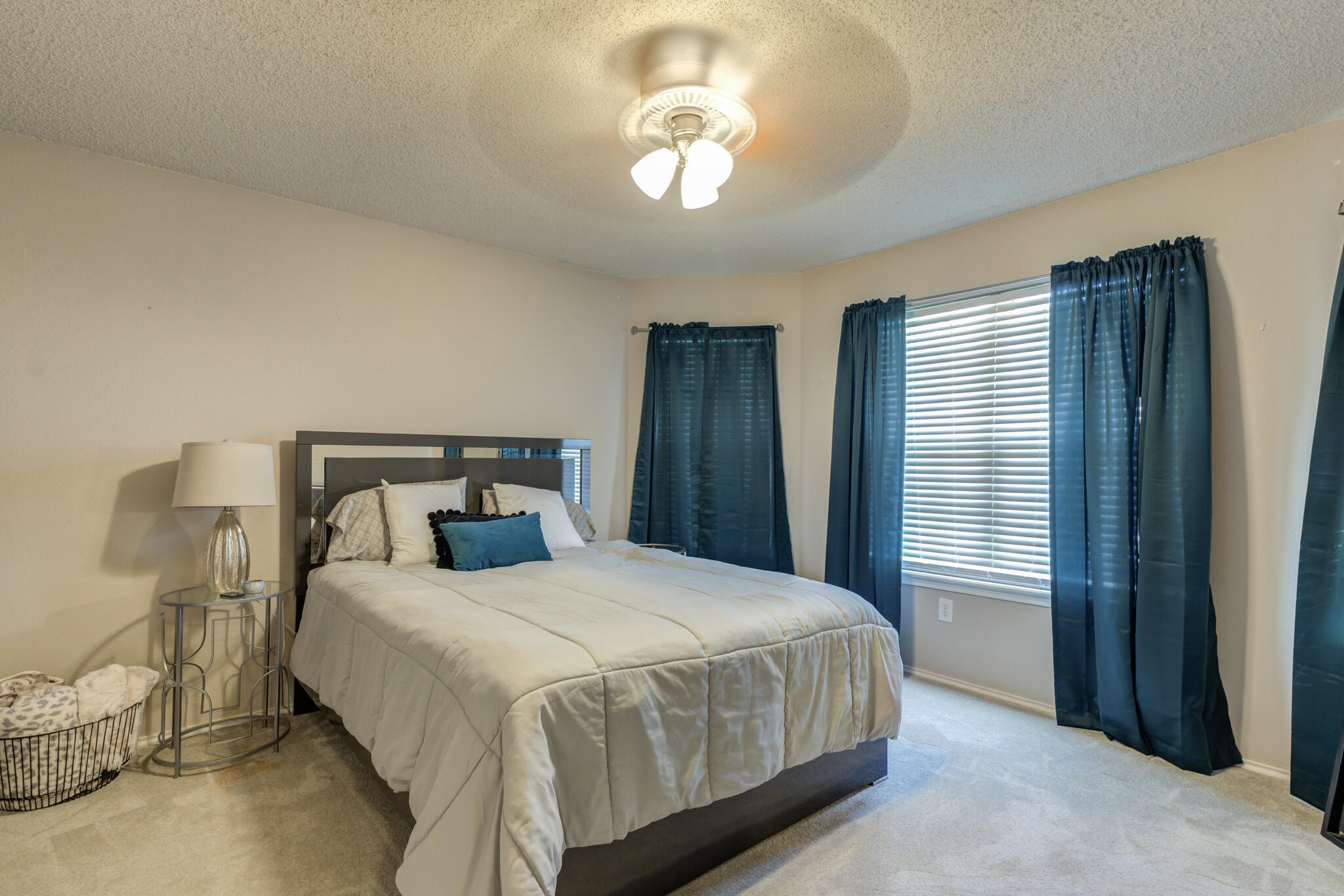 5813 88th Place Lubbock, TX 79424 - Photo 7 of 30 a bedroom with a bed and a chandelier