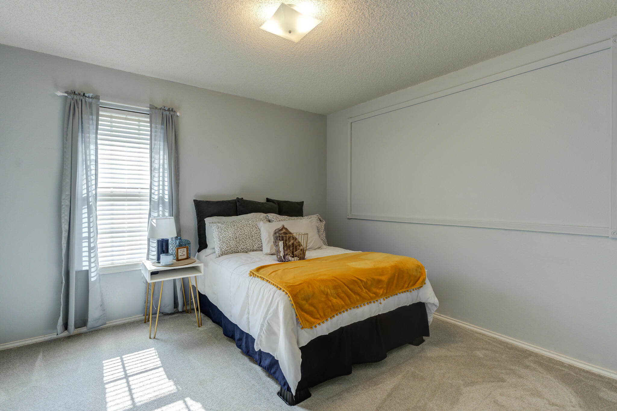 5813 88th Place Lubbock, TX 79424 - Photo 8 of 30 a bed sitting in a bedroom next to a window