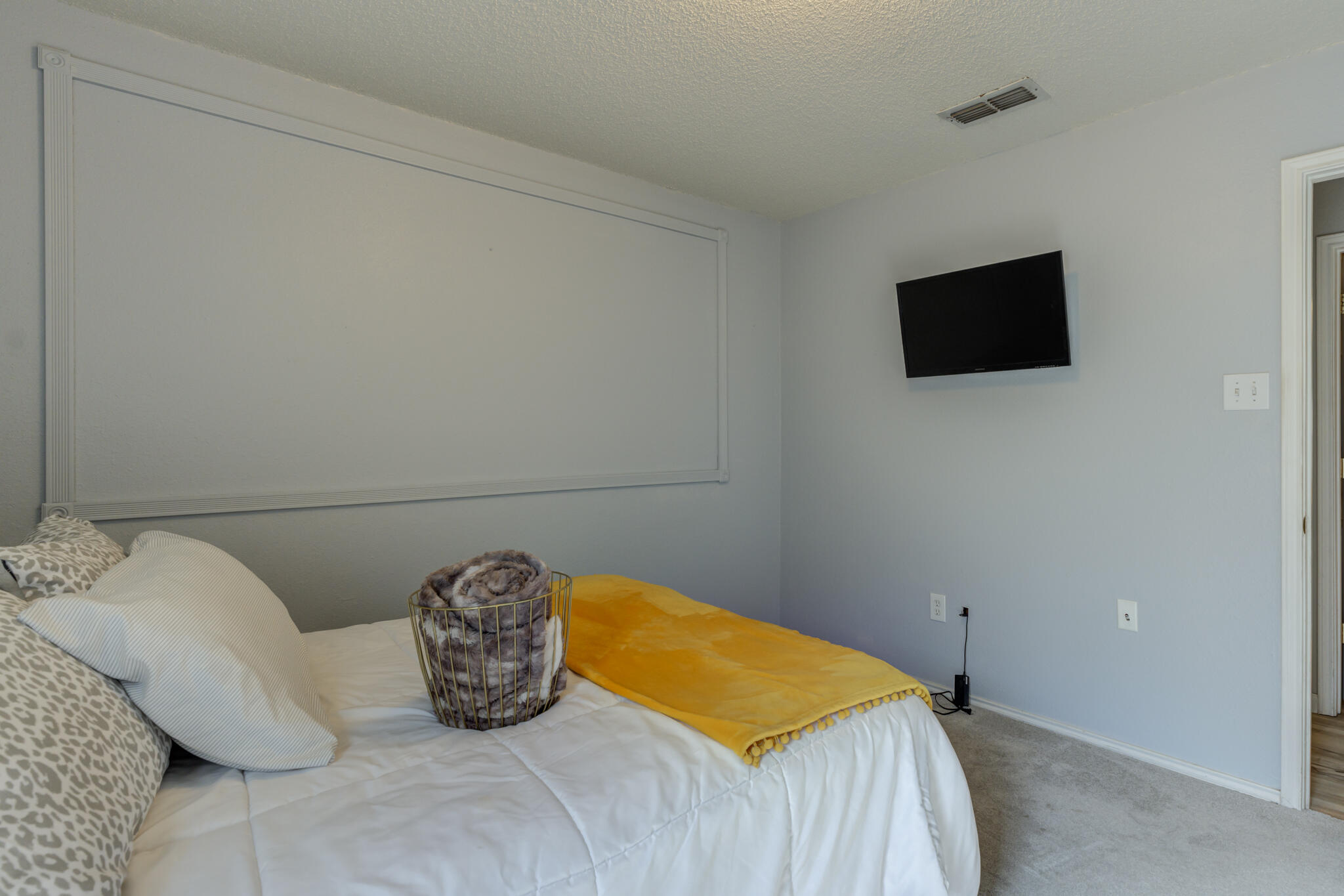 5813 88th Place Lubbock, TX 79424 - Photo 9 of 30 a bedroom with a bed and a television