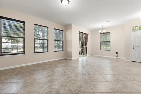 an empty room with windows and cabinet