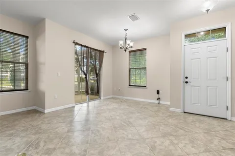 an empty room with windows and entrance