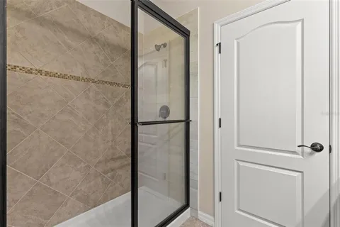 a bathroom with a glass shower door