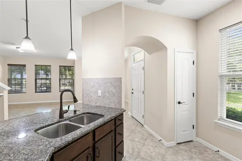 a kitchen with stainless steel appliances granite countertop a sink and a refrigerator