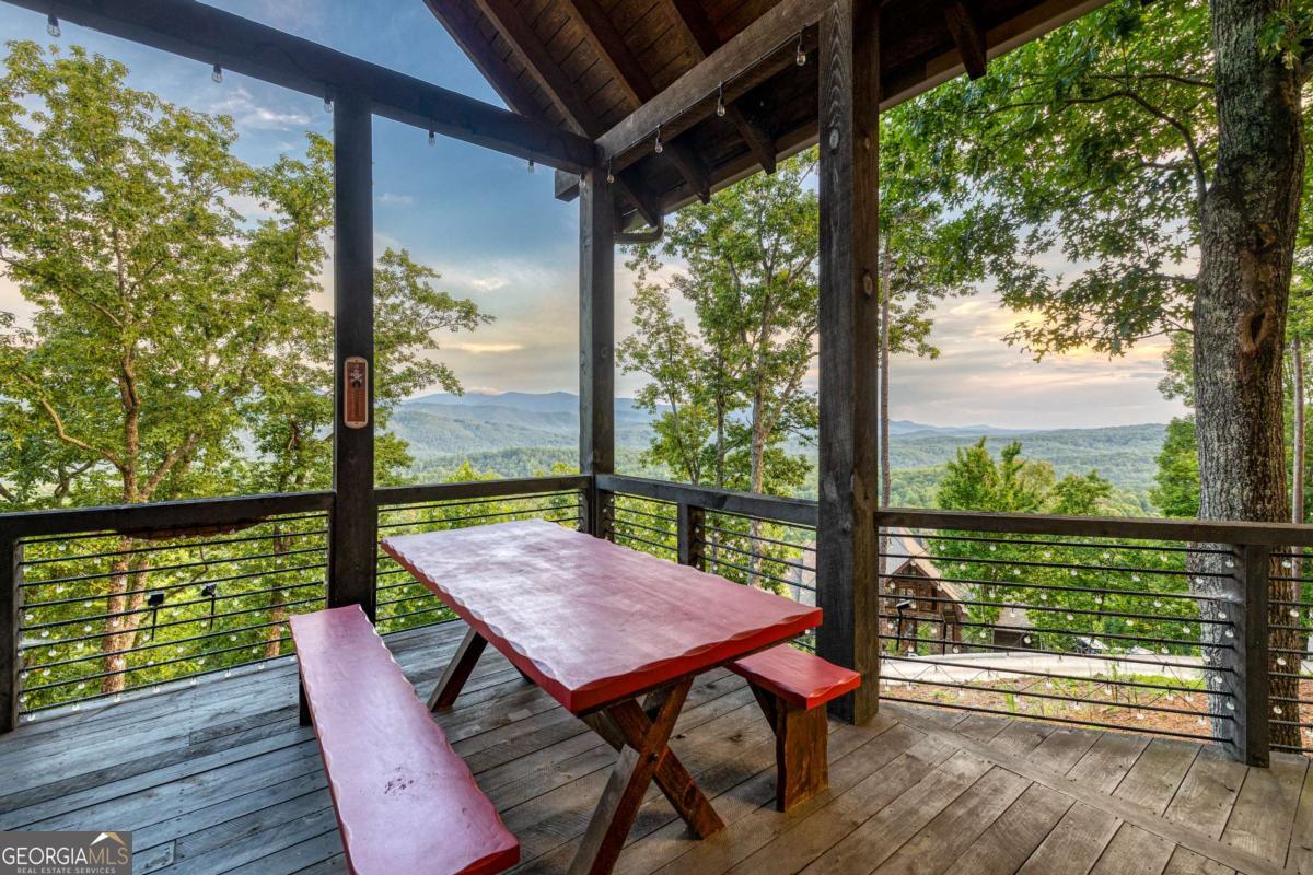 280 Pointe Of View, Unit 15 Blue Ridge, GA 30513 - Photo 32 of 72 a view of a porch with furniture and wooden floor