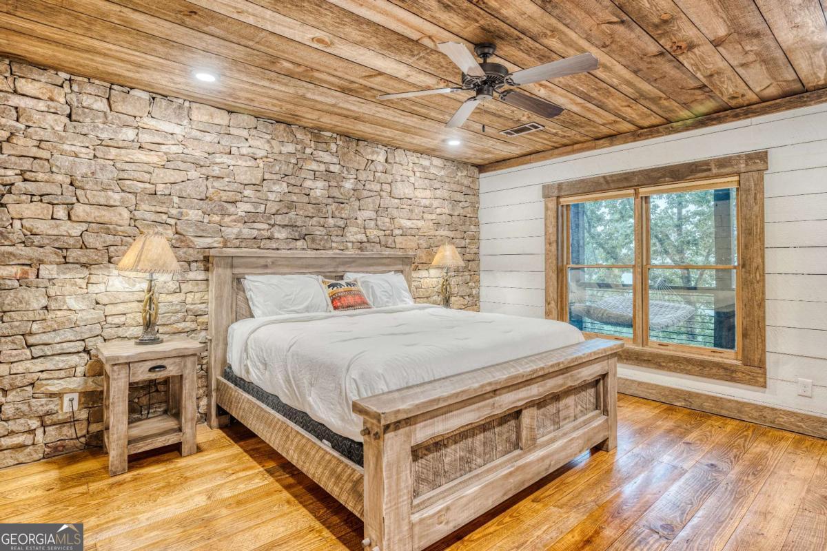 280 Pointe Of View, Unit 15 Blue Ridge, GA 30513 - Photo 38 of 72 a bed sitting in a spacious bedroom next to a window