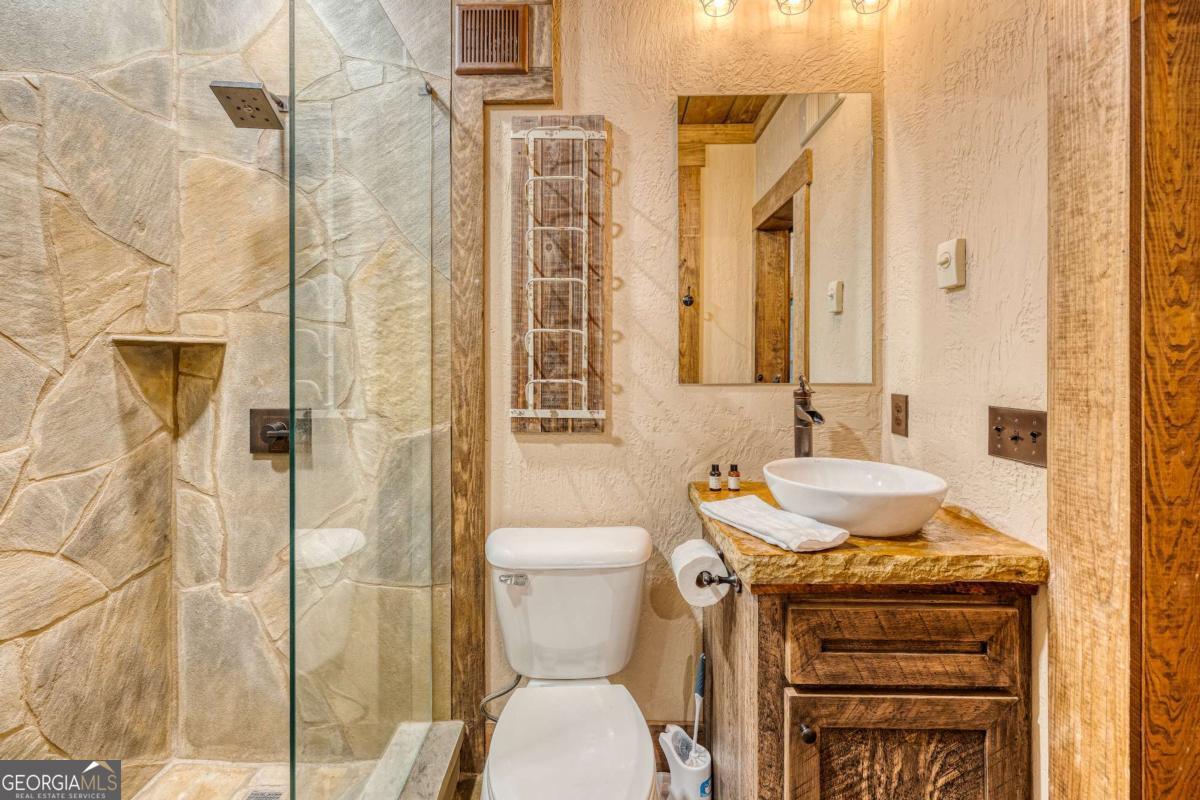 280 Pointe Of View, Unit 15 Blue Ridge, GA 30513 - Photo 56 of 72 a bathroom with a granite countertop sink and a toilet