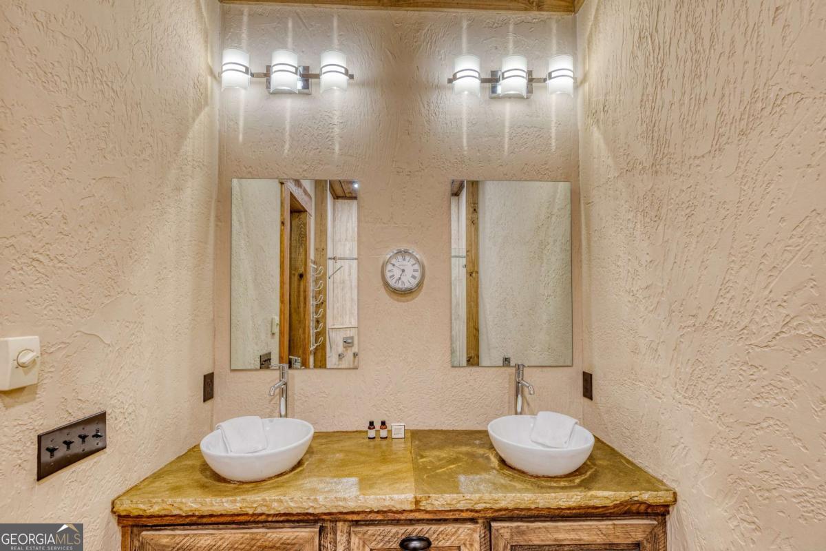 280 Pointe Of View, Unit 15 Blue Ridge, GA 30513 - Photo 65 of 72 a bathroom with a granite countertop sink and a mirror