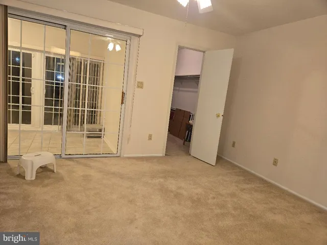 a view of a livingroom with a ceiling fan and window