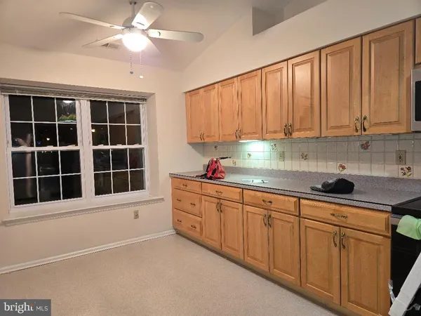 a kitchen with granite countertop a sink stainless steel appliances and cabinets