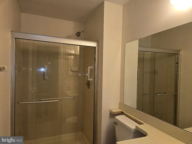 a bathroom with a shower and a glass door