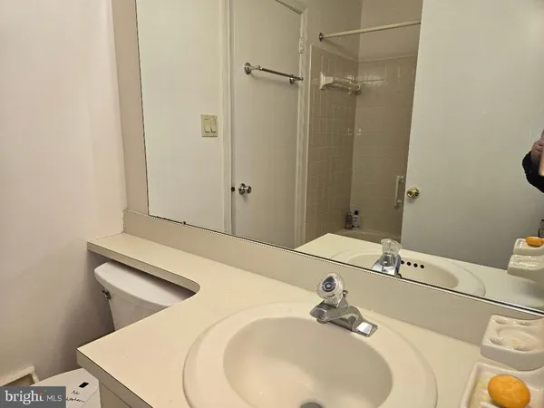 a bathroom with a sink a toilet and vanity
