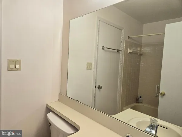 a bathroom with a shower and a sink