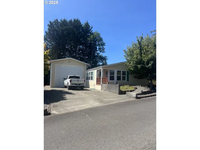 a view of a terrace with a table and chairs under an umbrella