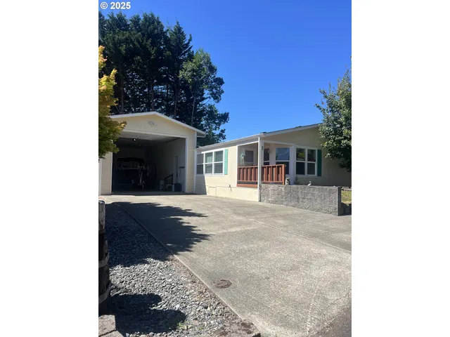 a view of a house with a yard and potted plants
