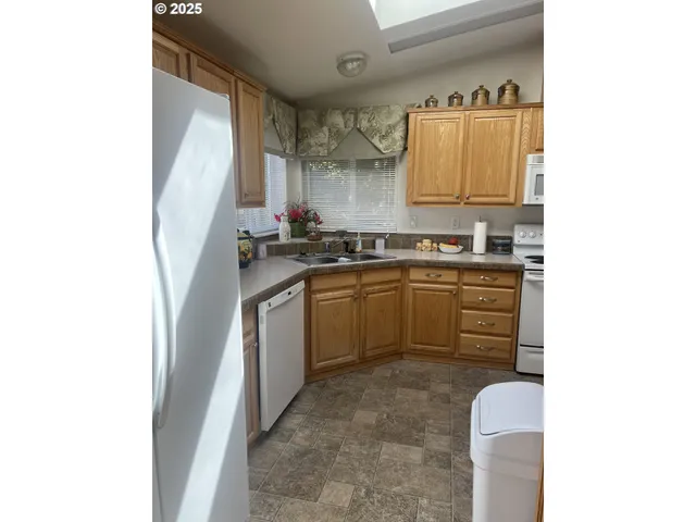 a kitchen with a sink cabinets and window
