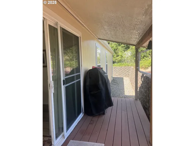 a view of a porch with wooden floor and stairs