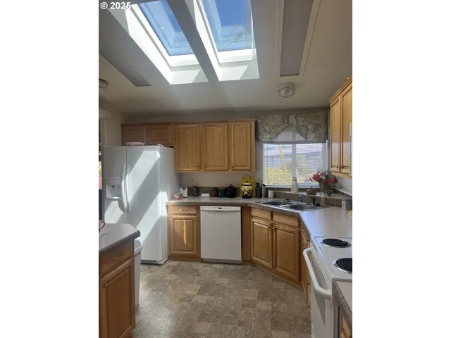 a kitchen with a sink cabinets and appliances