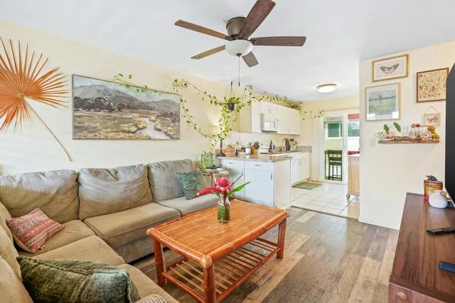 a living room with furniture a rug and a chandelier
