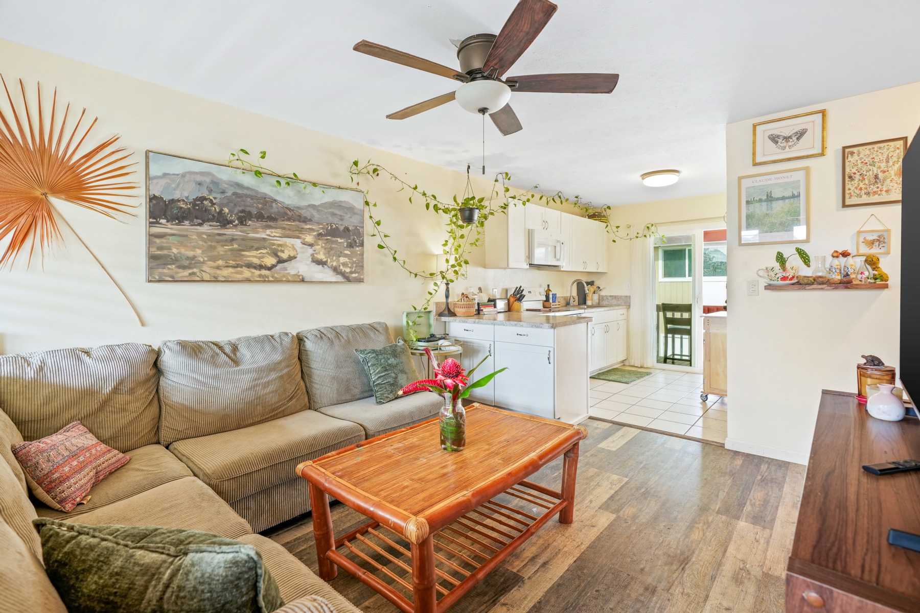 4461 Kamoa Road, Unit F21 Kapaa, HI 96746 - Photo 1 of 20 a living room with furniture a rug and a chandelier