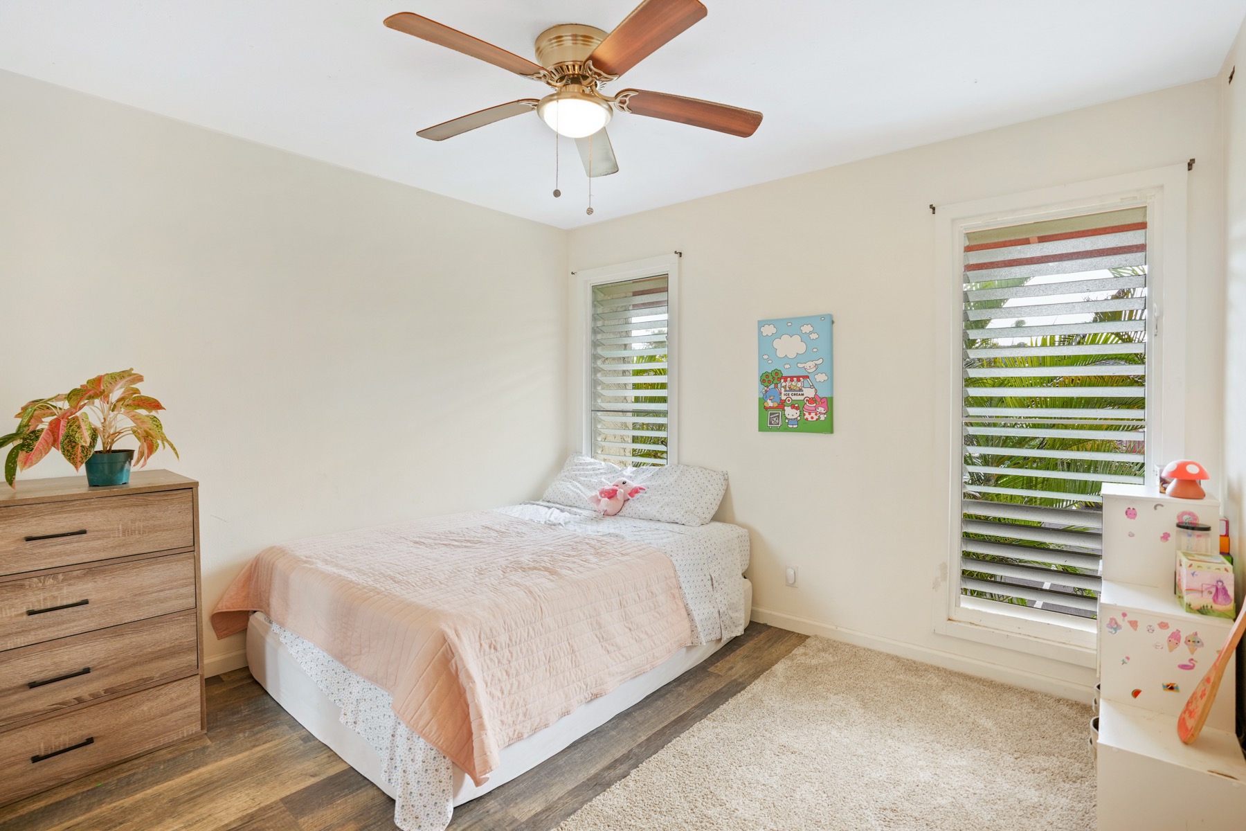 4461 Kamoa Road, Unit F21 Kapaa, HI 96746 - Photo 13 of 20 a bedroom with a bed and a chandelier fan