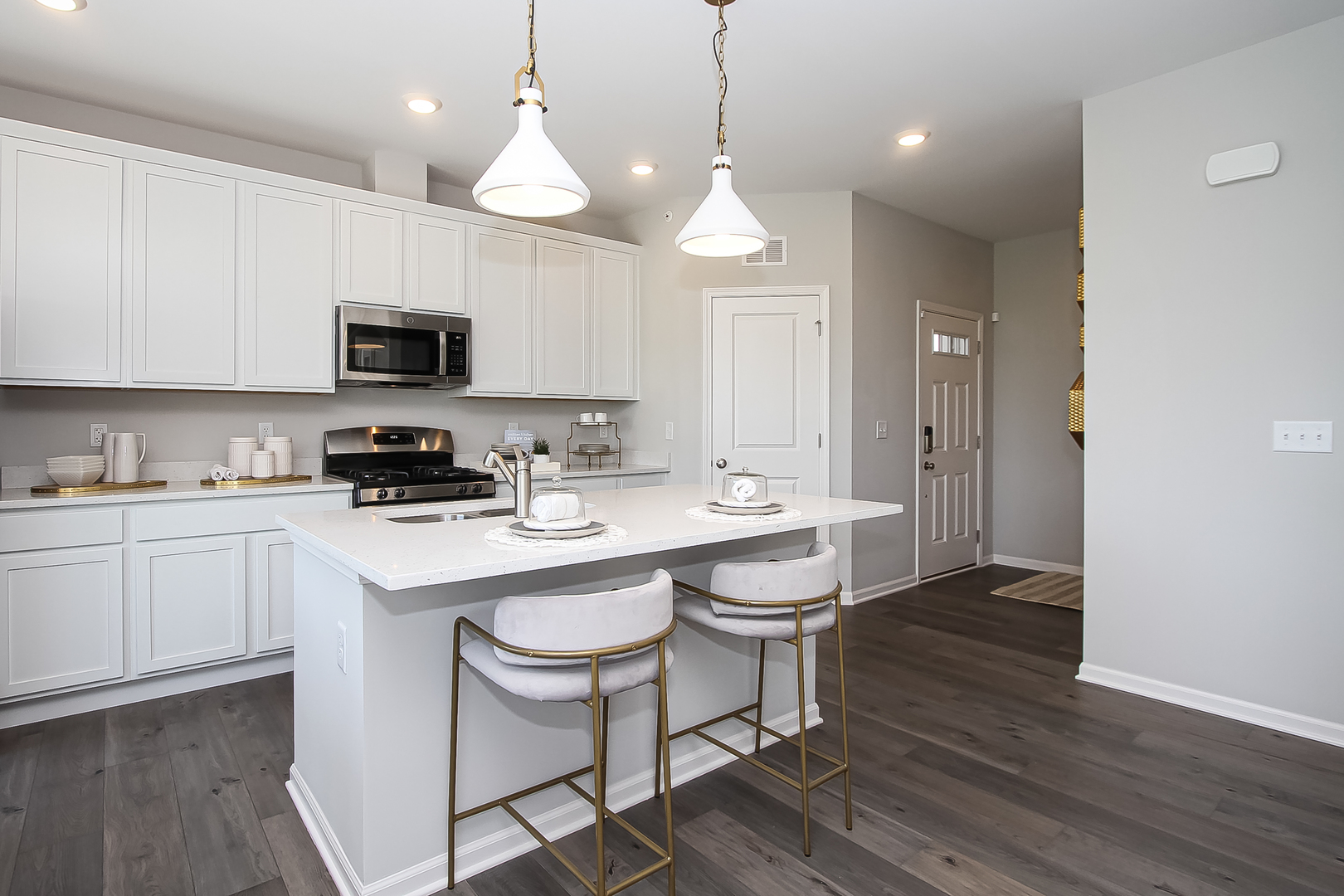 324 Kingsport Drive South Elgin, IL 60177 - Photo 8 of 25 a kitchen with a sink a microwave a stove and cabinets