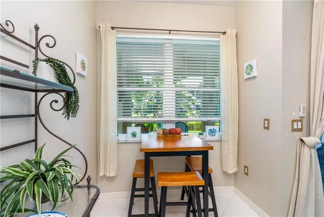 a dining room with furniture and a window
