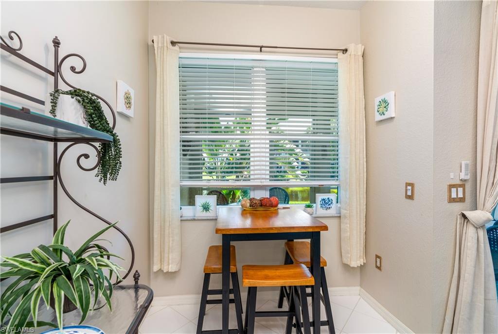 4680 Hawks Nest Way, Unit D103 Naples, FL 34114 - Photo 15 of 35 a dining room with furniture and a window