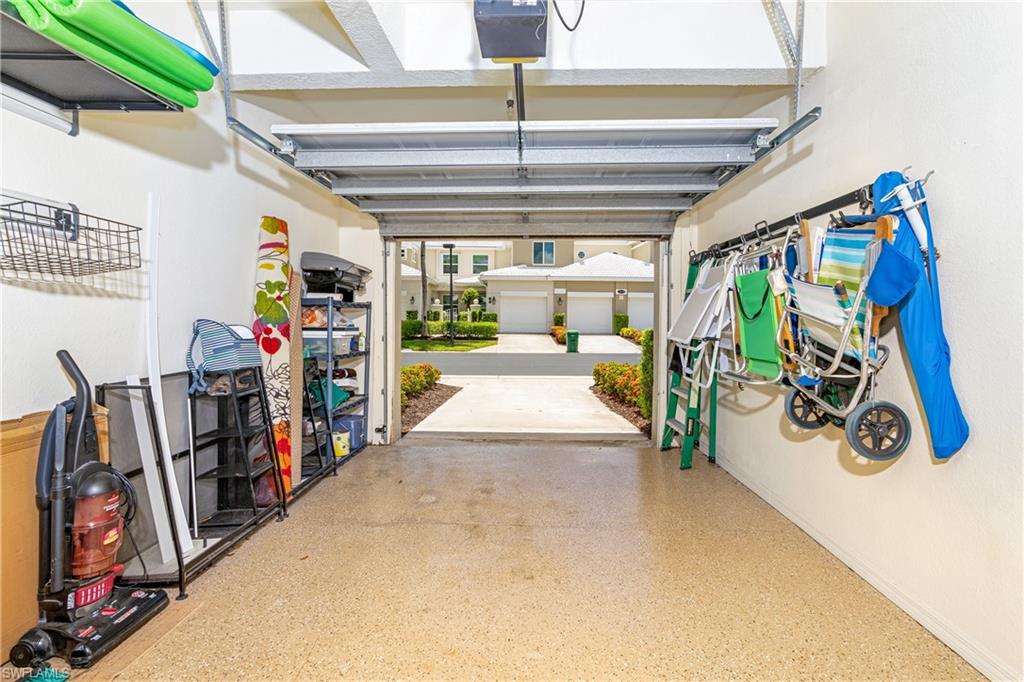 4680 Hawks Nest Way, Unit D103 Naples, FL 34114 - Photo 17 of 35 a view of a garage with rack and bicycle