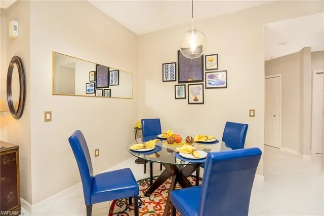 a view of a dining room with furniture and a chandelier