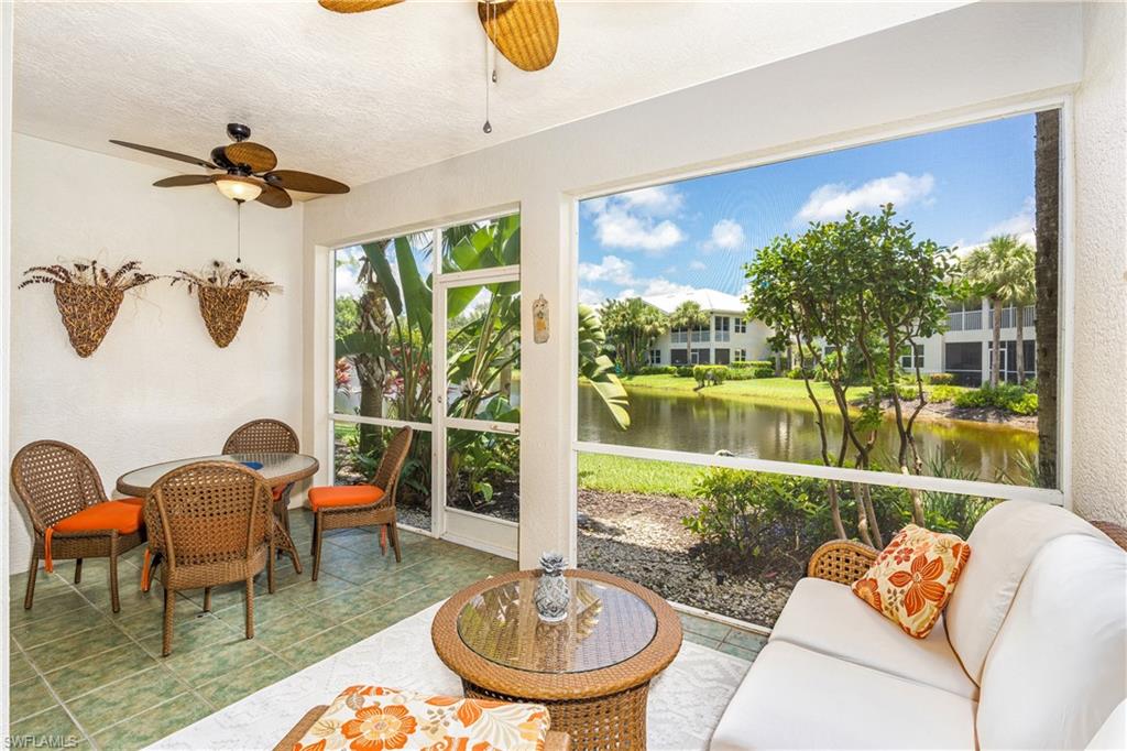 4680 Hawks Nest Way, Unit D103 Naples, FL 34114 - Photo 8 of 35 a living room with patio furniture and a fireplace