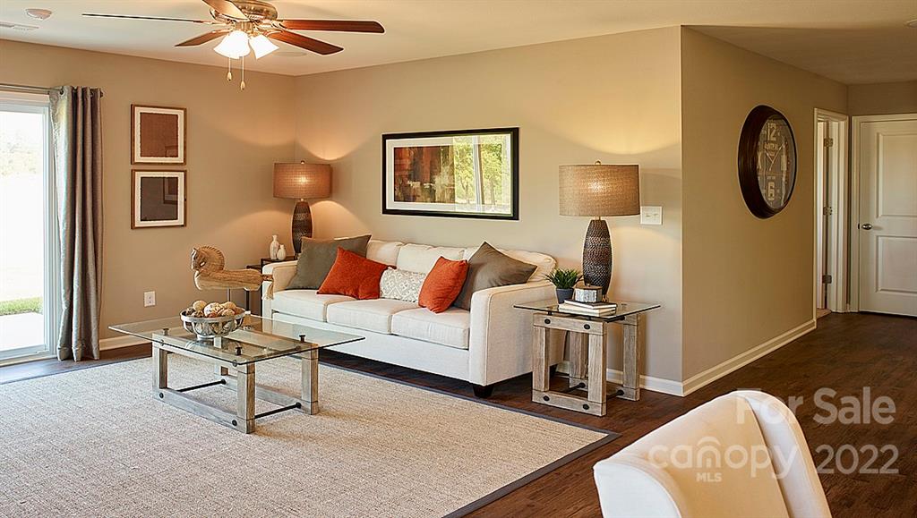 304 Gaines Road Clover, SC 29710 - Photo 13 of 48 a living room with furniture a clock on wall and a window