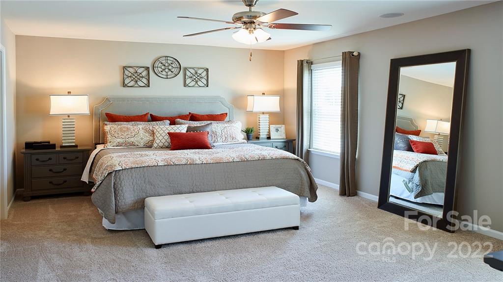 304 Gaines Road Clover, SC 29710 - Photo 42 of 48 a spacious bedroom with a bed and a chandelier