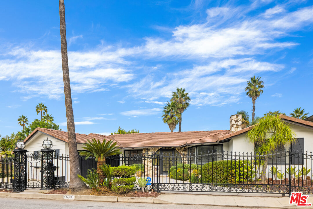 2254 Stradella Road Los Angeles, CA 90077 - Photo 2 of 27 a front view of a house with garden