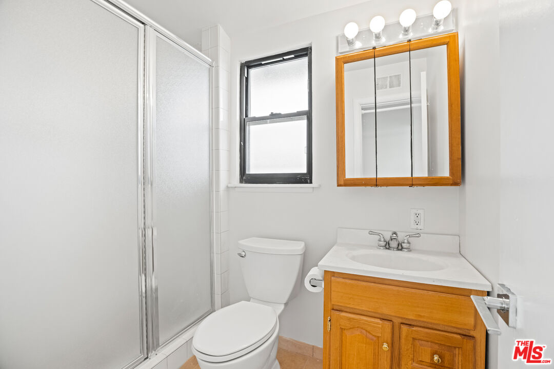 2254 Stradella Road Los Angeles, CA 90077 - Photo 17 of 27 a bathroom with a sink a toilet and shower