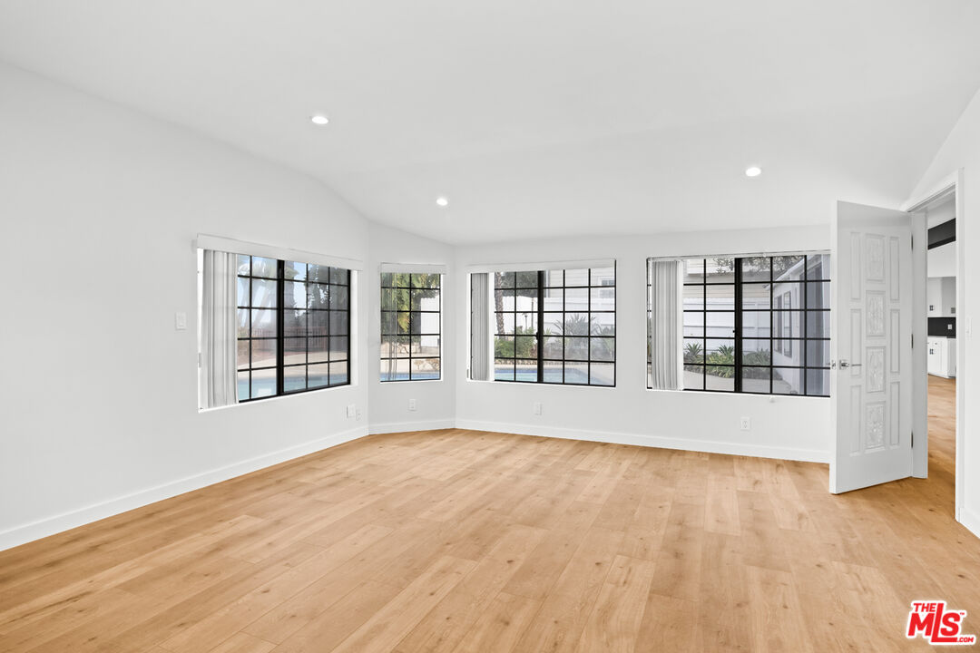 2254 Stradella Road Los Angeles, CA 90077 - Photo 19 of 27 a view of an empty room with a window and wooden floor