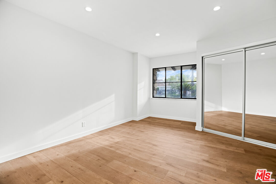 2254 Stradella Road Los Angeles, CA 90077 - Photo 23 of 27 an empty room with windows