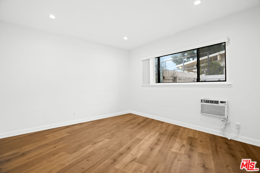 2254 Stradella Road Los Angeles, CA 90077 - Photo 24 of 27 an empty room with wooden floor and windows