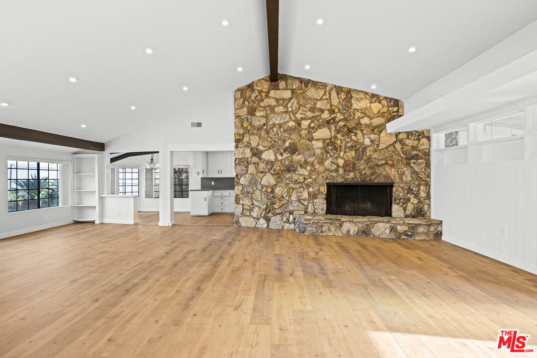 2254 Stradella Road Los Angeles, CA 90077 - Photo 9 of 27 a view of livingroom with fireplace and window