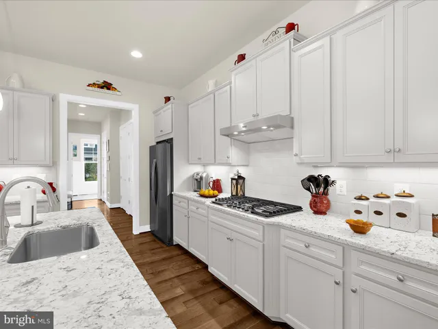 a en suite bathroom with a granite countertop sink and a mirror