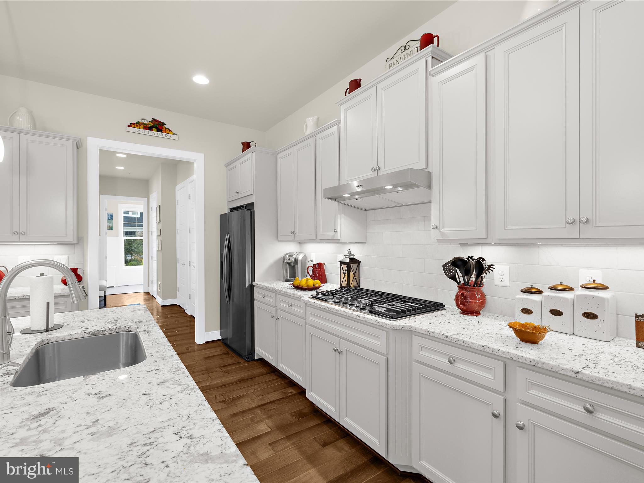 1530 Yellow Sand Lane Odenton, MD 21113 - Photo 17 of 87 a kitchen with stainless steel appliances granite countertop a sink dishwasher and white cabinets with wooden floor